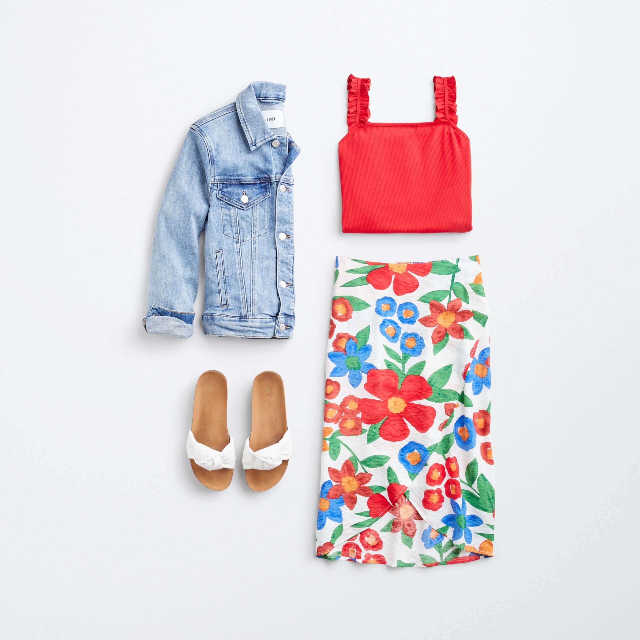 Stitch Fix women’s outfit laydown featuring colorful floral print skirt, pink cropped tank, white slide sandals and denim jacket..