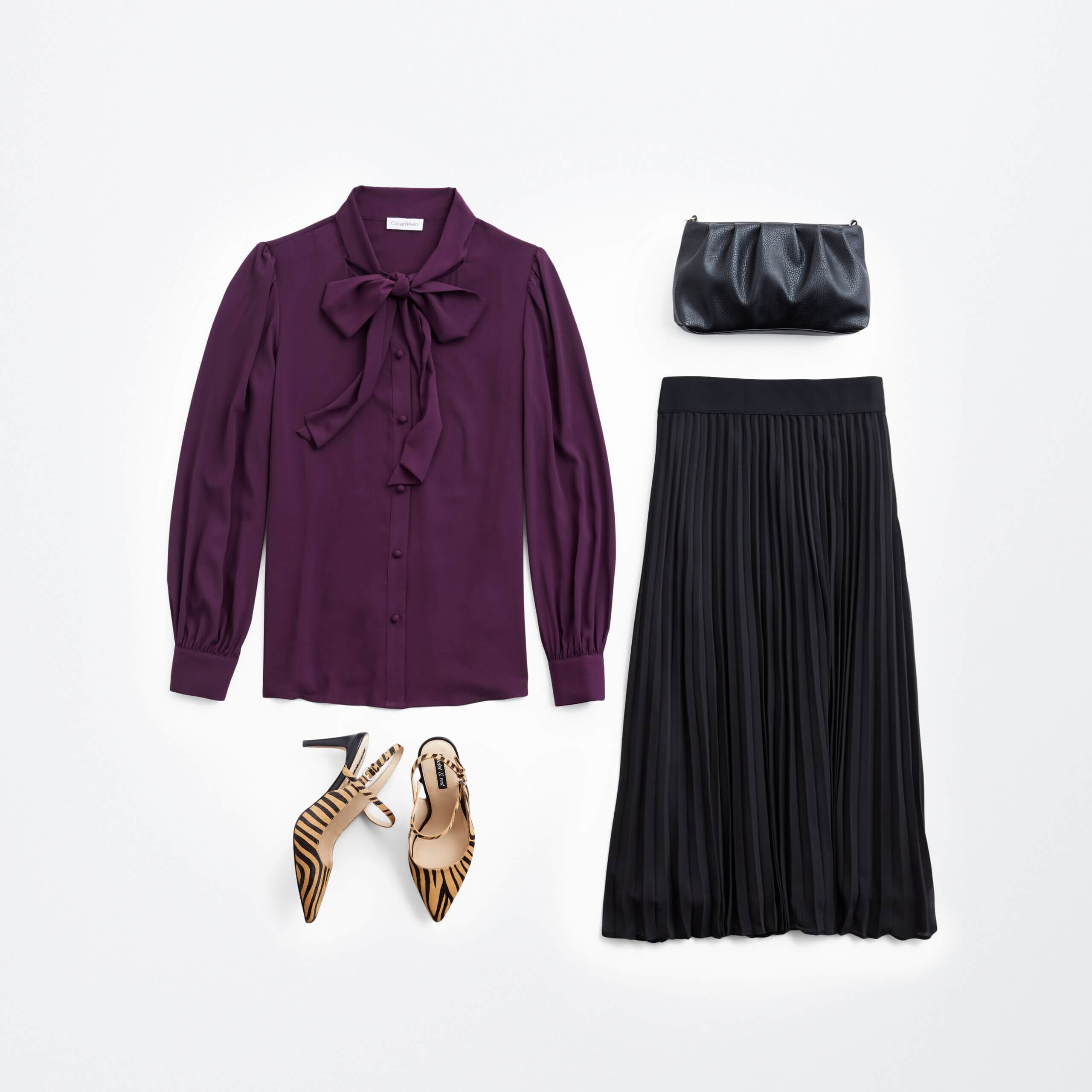 Stitch Fix women’s holiday party outfit featuring black pleated maxi skirt, purple tie-neck blouse, black clutch and tiger-print heels.
