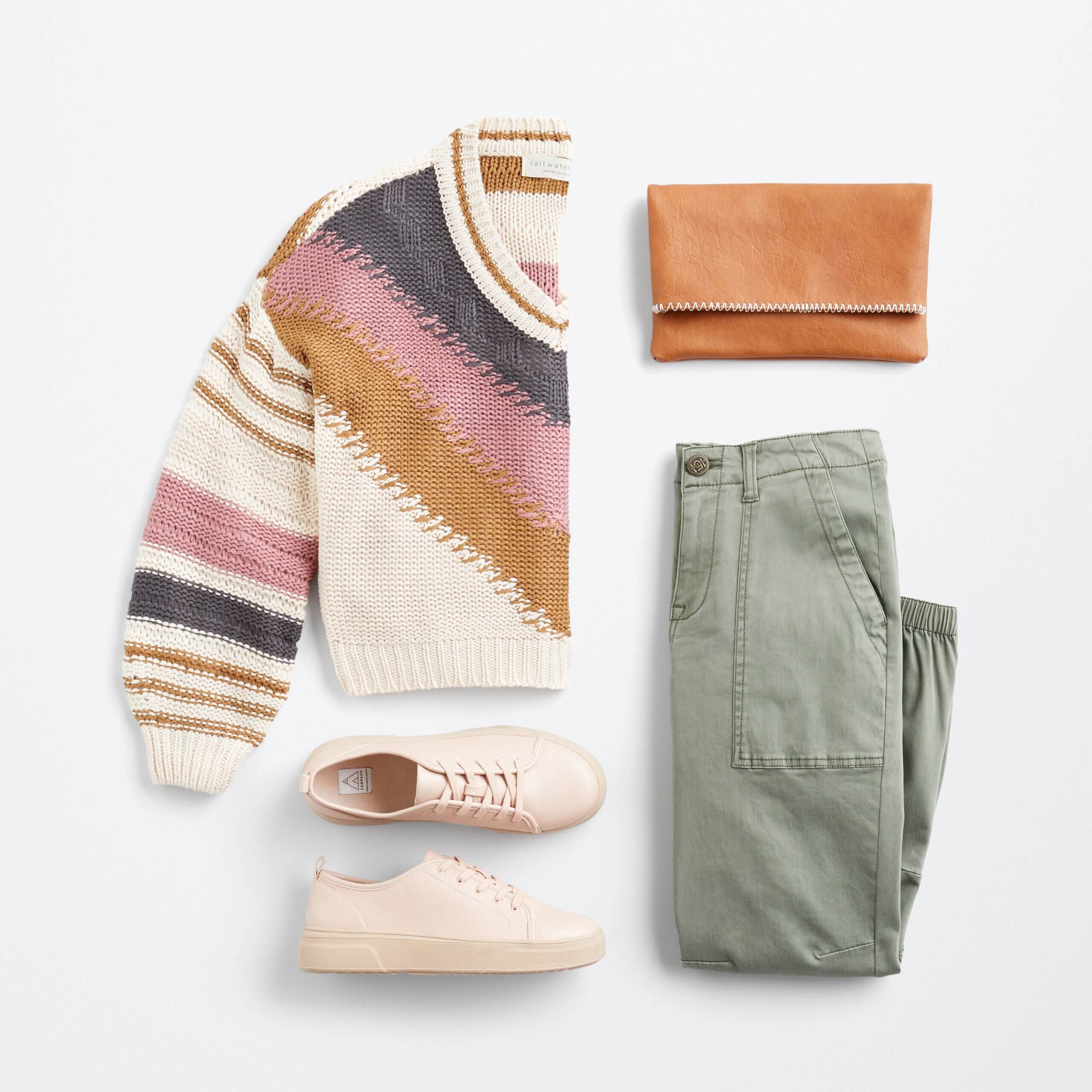 Stitch Fix women's outfit laydown featuring white v-neck pullover with blush pink, tan and navy stripes, olive green jogger pants, blush oink sneakers and a tan clutch. 