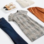 Stitch Fix women’s business attire outfit with plaid sheath dress, orange blouse, dark wash bootcut jeans, off-white cardigan and tan and black slingback flats.