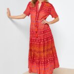 Stitch Fix women's model wearing boho style outfit featuring red printed midi dress and brown boots.