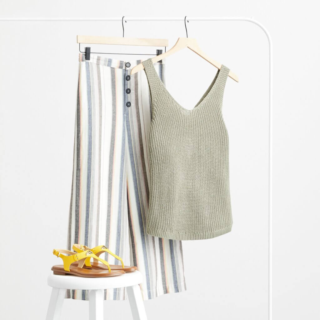 Stitch Fix women’s striped gauchos with green knit tank and yellow sandals on a white stool.