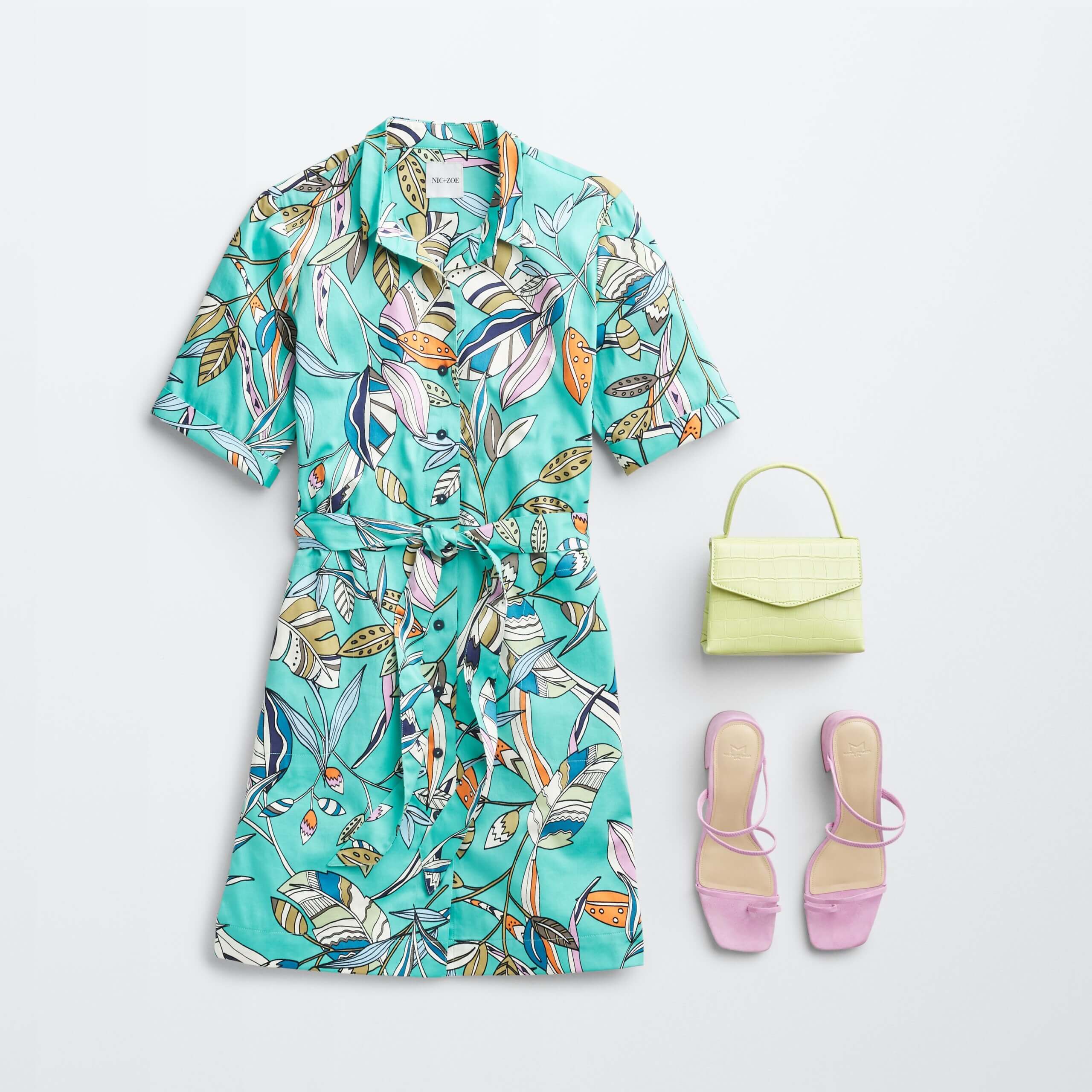 Stitch Fix women’s dress in leaf print, pink slide sandals and celery green crossbody bag.