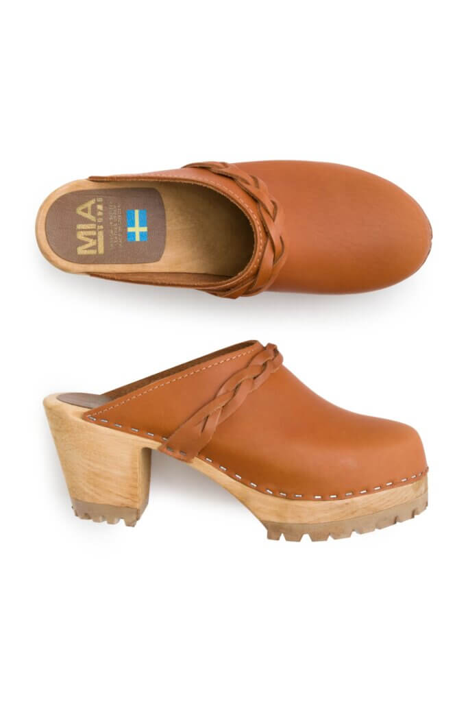 Stitch Fix Women’s Collection featuring tan leather clogs with braided strap detail.