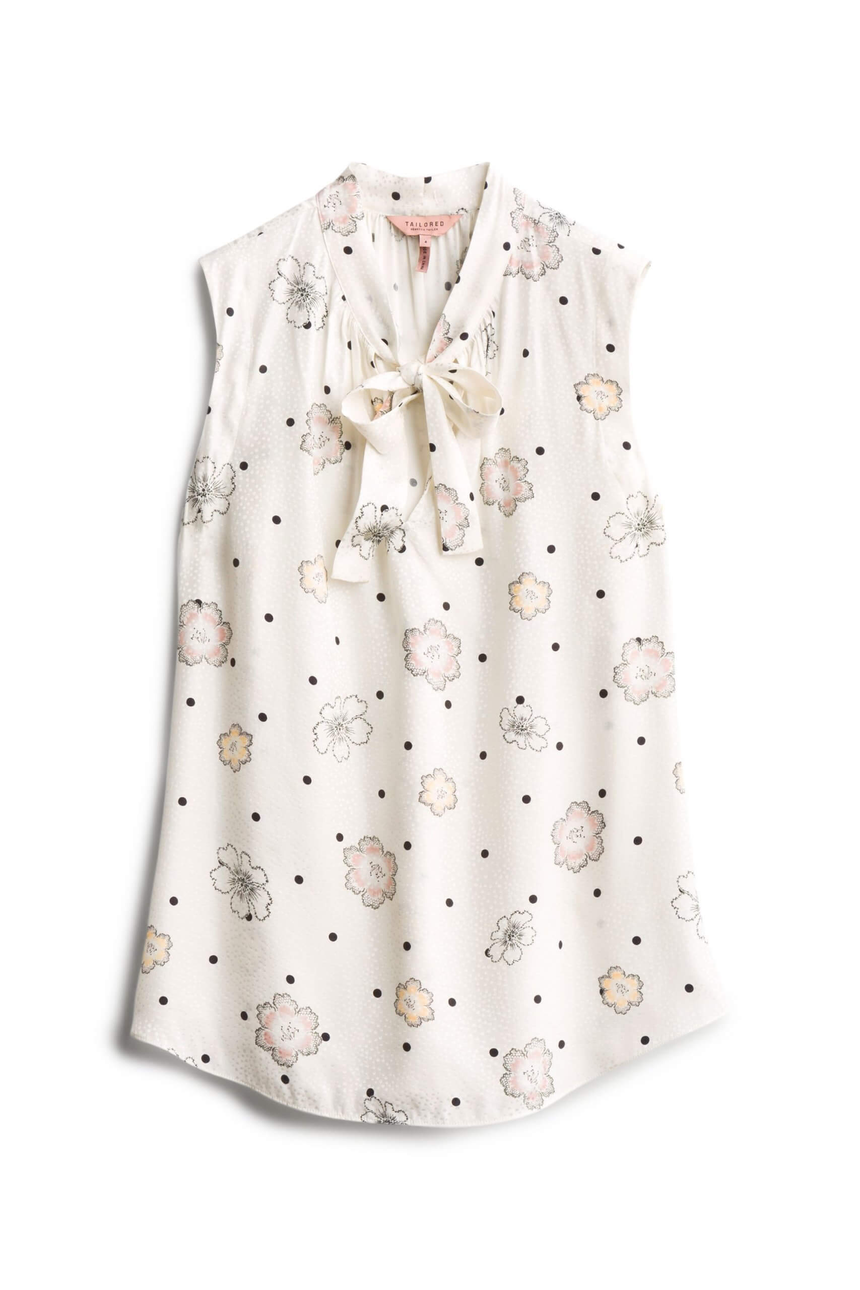 Stitch Fix women’s white sleeveless blouse in black polka dot and pink and orange floral print with tie-neck detail.