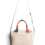 Stitch Fix women's white purse with scarf-wrapped handles.
