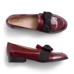 Stitch Fix women’s patent red leather loafers with black bows.