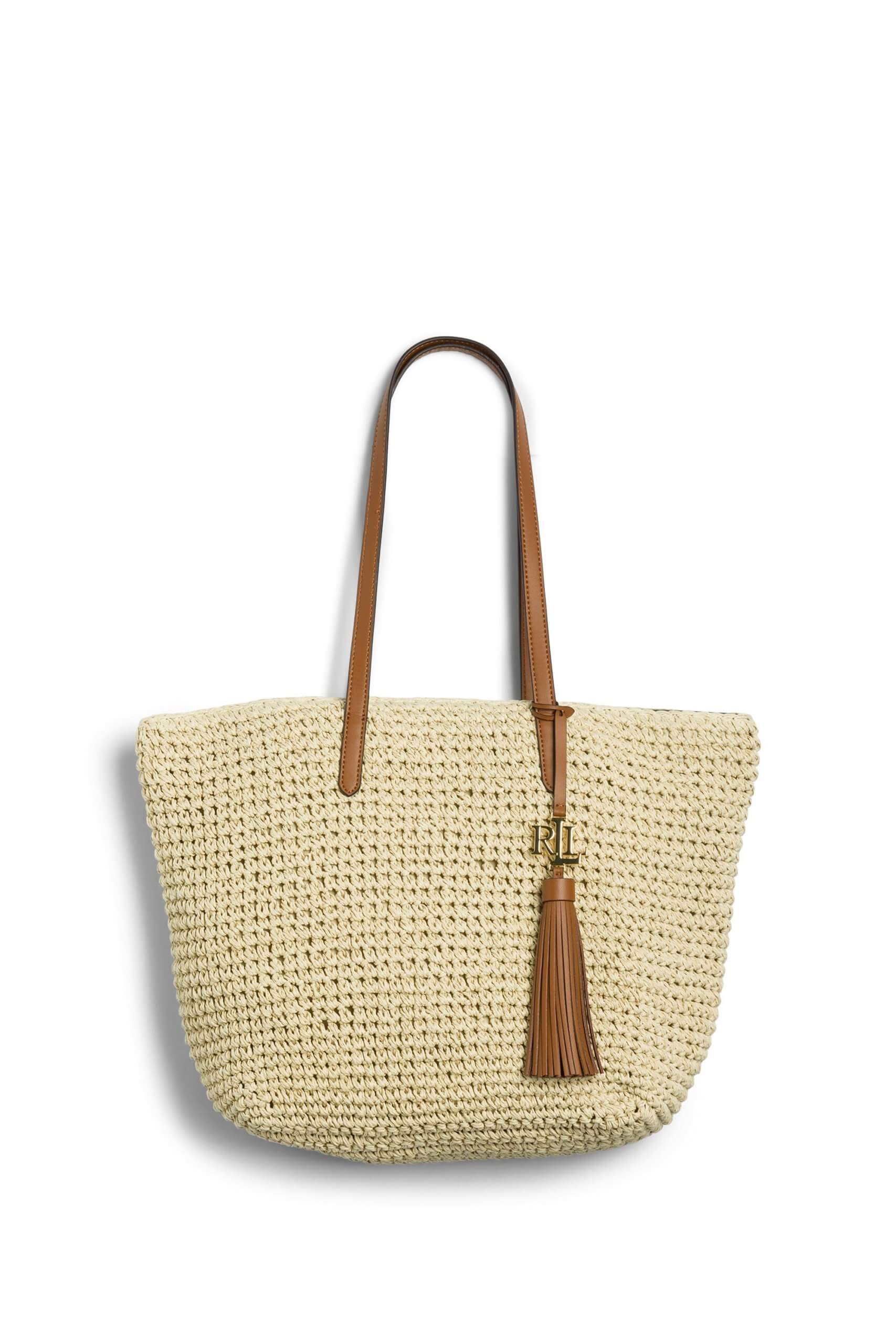 Stitch Fix women’s cream woven tote bag with brown leather handle and tassel.
