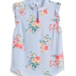 Stitch Fix women’s light blue blouse with pink, yellow, white and green floral print with ruffle neckline and shoulder detail.