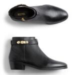 Stitch Fix women’s black ankle boots with gold trim detail.