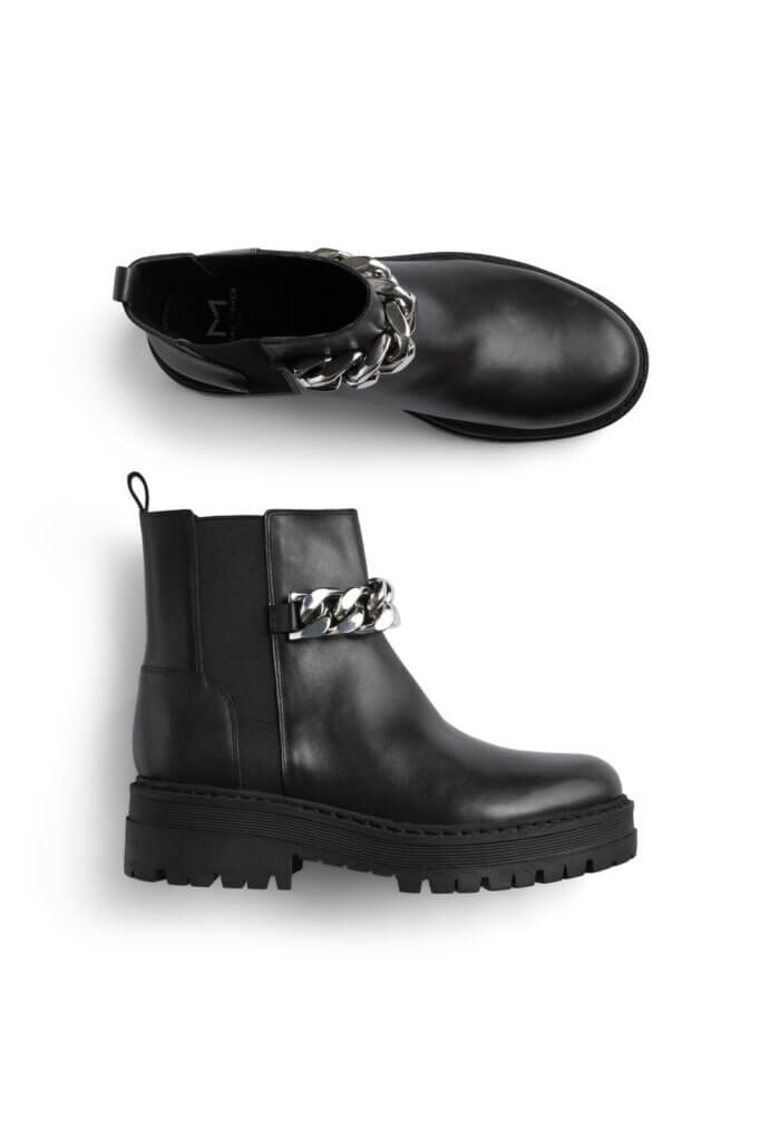 Stitch Fix women’s black leather Chelsea boots with silver chain.