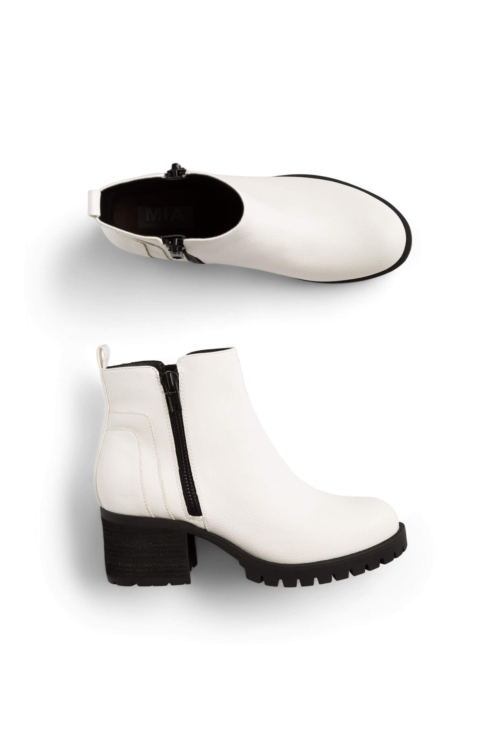 Stitch Fix women’s white ankle boots with black stacked sole and zipper detail.