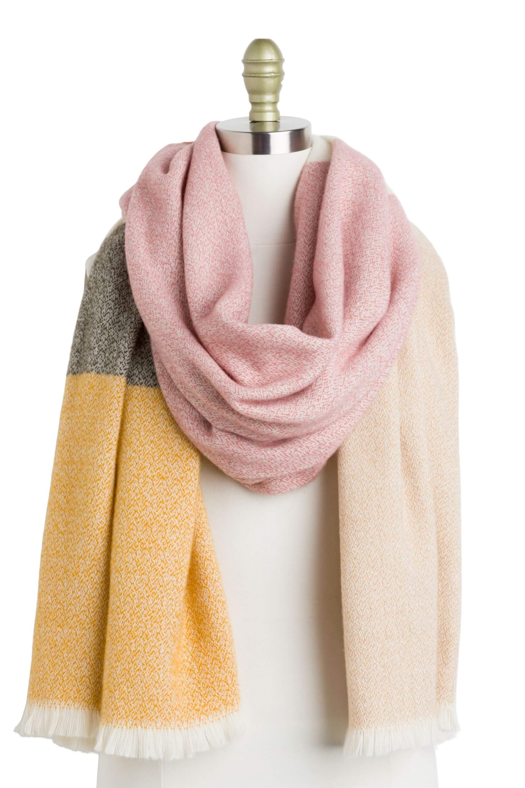 Stitch Fix women’s yellow, light pink, off-white and green color-block blanket scarf with fringe ends on bust form.