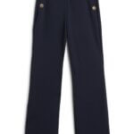 Stitch Fix women’s navy flare pants with gold buttons.