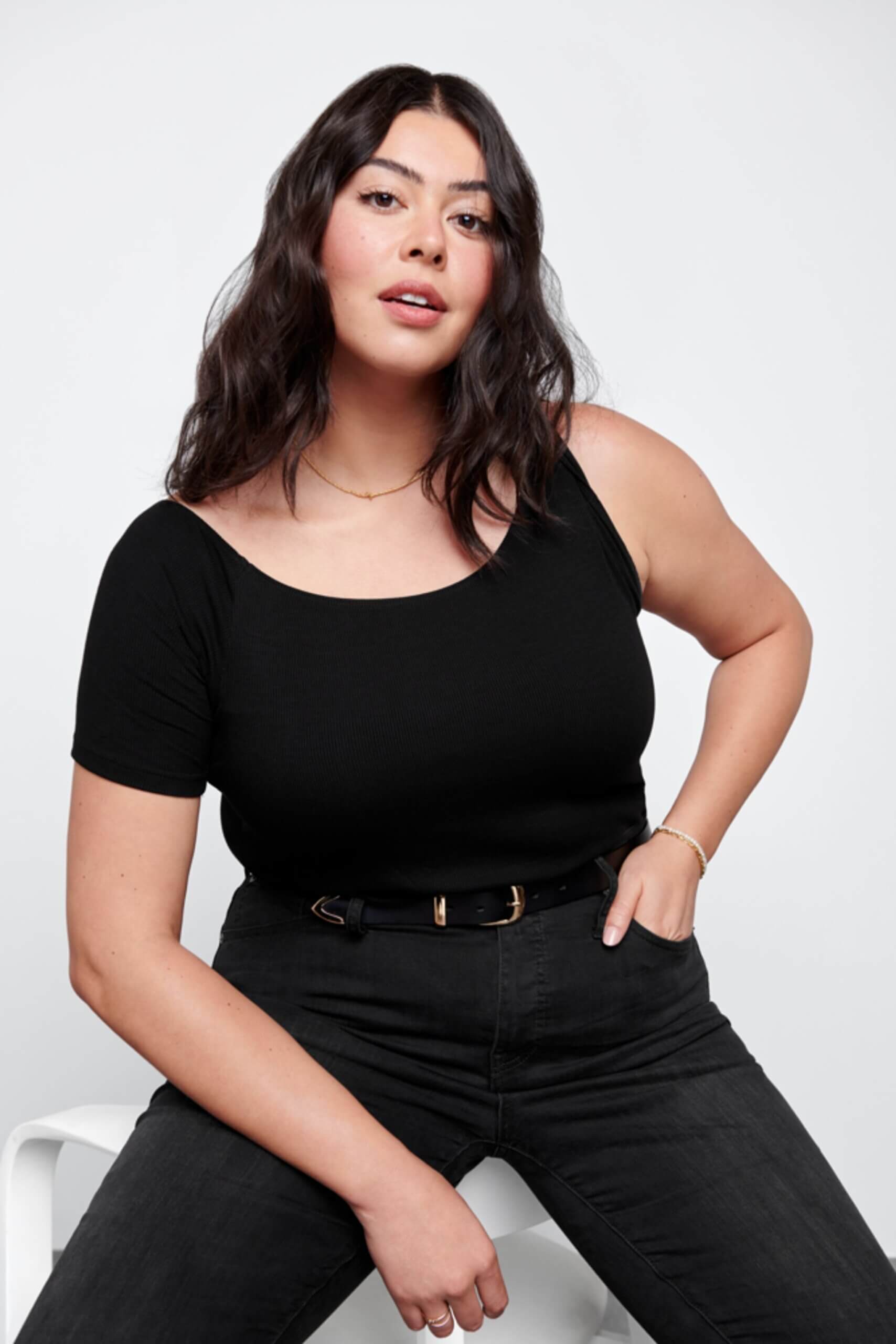 Stitch Fix Women’s model wearing a grunge outfit with black jeans, belt and one-shoulder T-shirt.