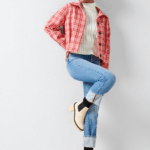 Stitch Fix Women’s model wearing a pumpkin patch outfit with a white turtleneck, jeans, pink plaid jacket and white boots.