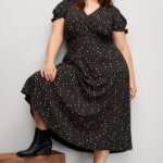 Stitch Fix Women’s model wearing a grunge style outfit with a midi dress, booties and beanie.