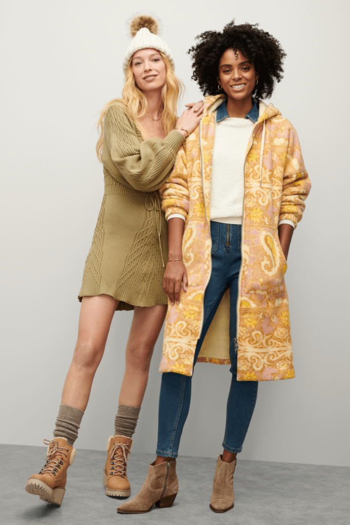 Stitch Fix Women’s model wearing sweater dress, boots and beanie. Second model wearing sweater, jeans, boots and paisley jacket.