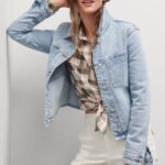 Stitch Fix Women’s model wearing a pink and grey plaid button-up, white cargo pants and light blue jean jacket.