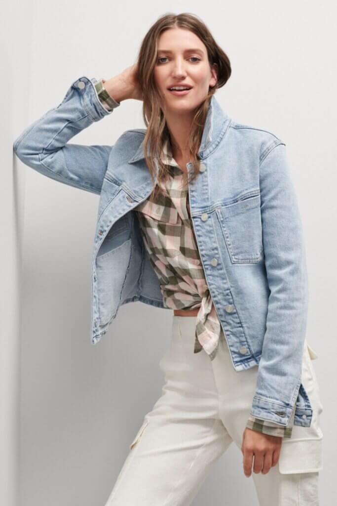 Stitch Fix Women’s model wearing a pink and grey plaid button-up, white cargo pants and light blue jean jacket.