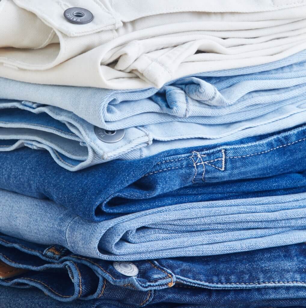 Stitch Fix Women’s stack of blue and white straight-leg jeans.