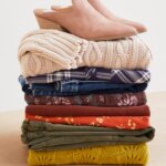 Stitch Fix Women’s stack of pumpking patch style fall sweaters, flannels, blouses and a pair of mule heels.