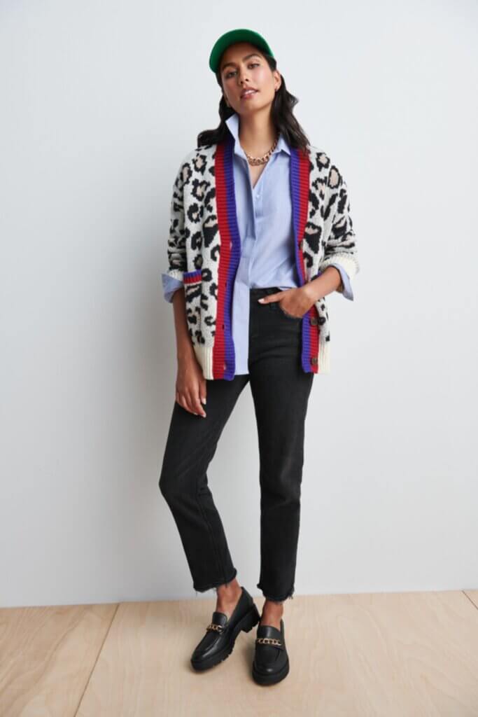 Stitch Fix Women’s model wearing a blue button-up, black jeans, animal print cardigan and black loafers.