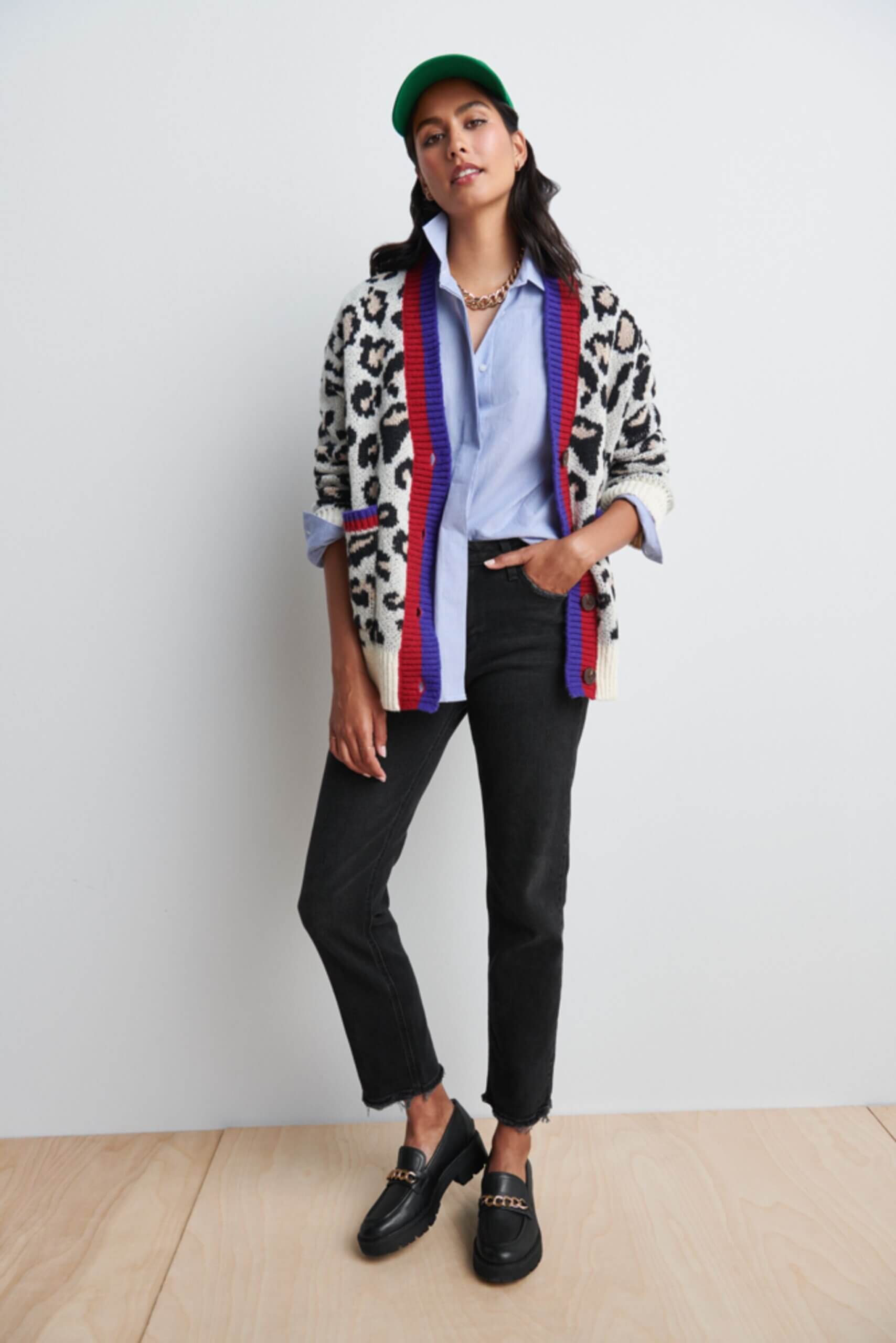 Stitch Fix Women’s model wearing a blue button-up, black jeans, animal print cardigan and black loafers.