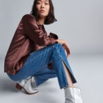 Stitch Fix Women’s outfit example of how to wear ankle boots with straight-leg jeans and satin blouse.