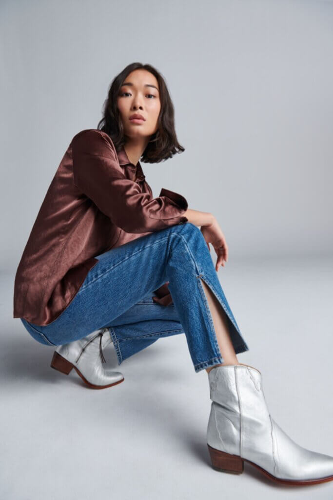 Stitch Fix Women’s outfit example of how to wear ankle boots with straight-leg jeans and satin blouse.