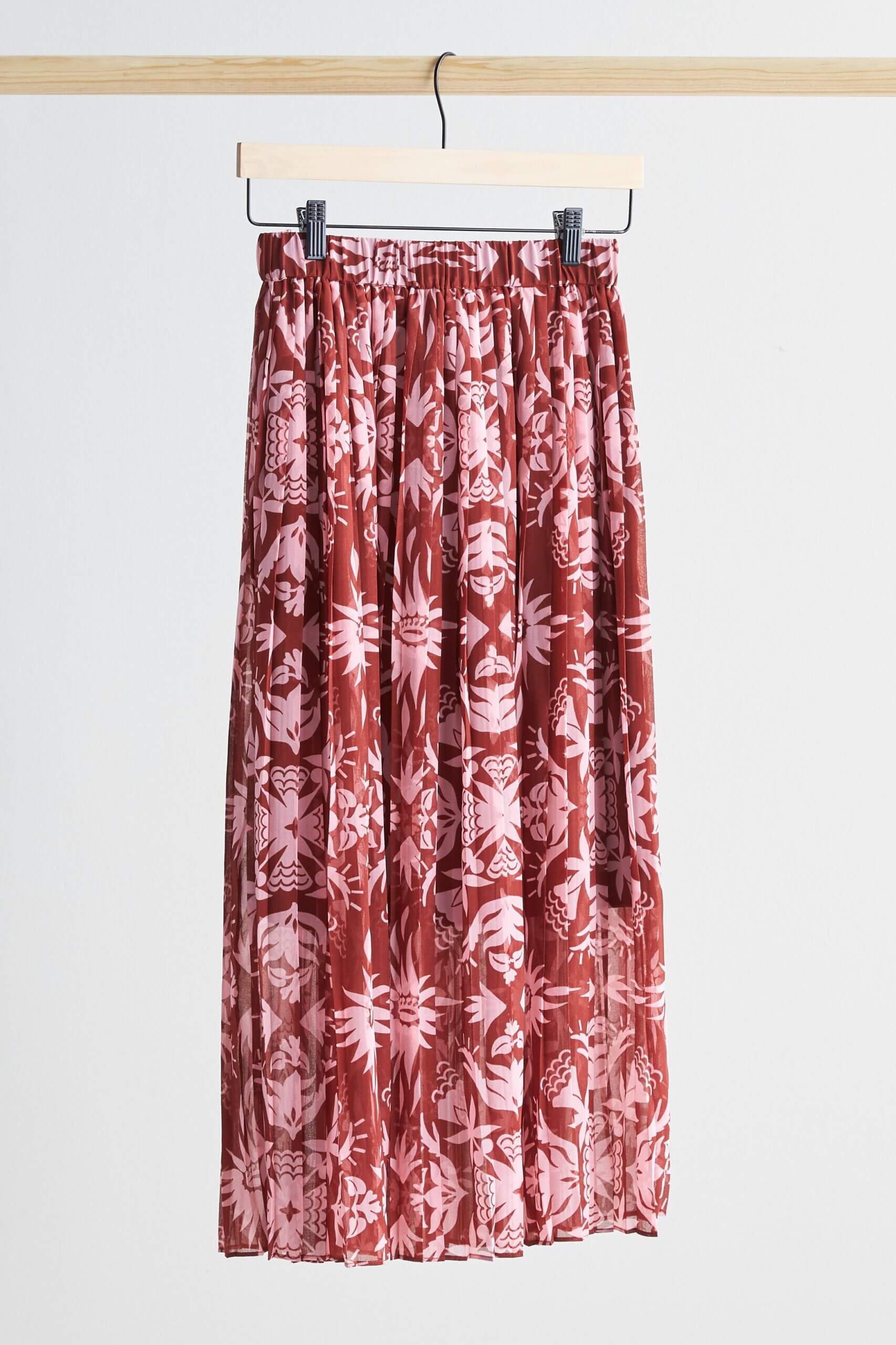 Stitch Fix women’s printed pleated midi skirt hanging from clothes rack.