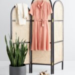 Stitch Fix women’s business formal outfit with coral belted shirt dress and beige blazer hanging up next to brown heels.