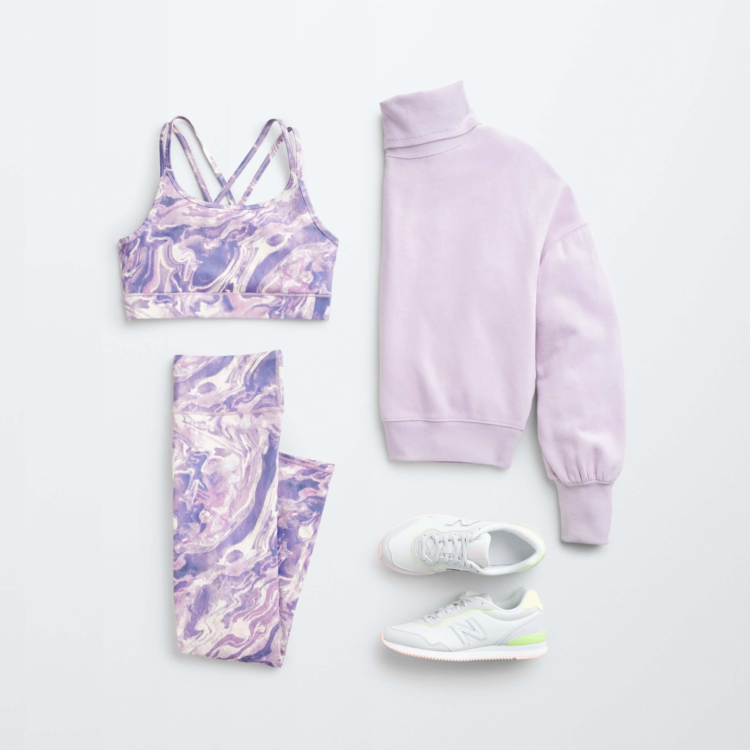 Stitch Fix women’s hiking outfit with purple and white printed sports bra and leggings, lilac turtleneck and white sneakers.