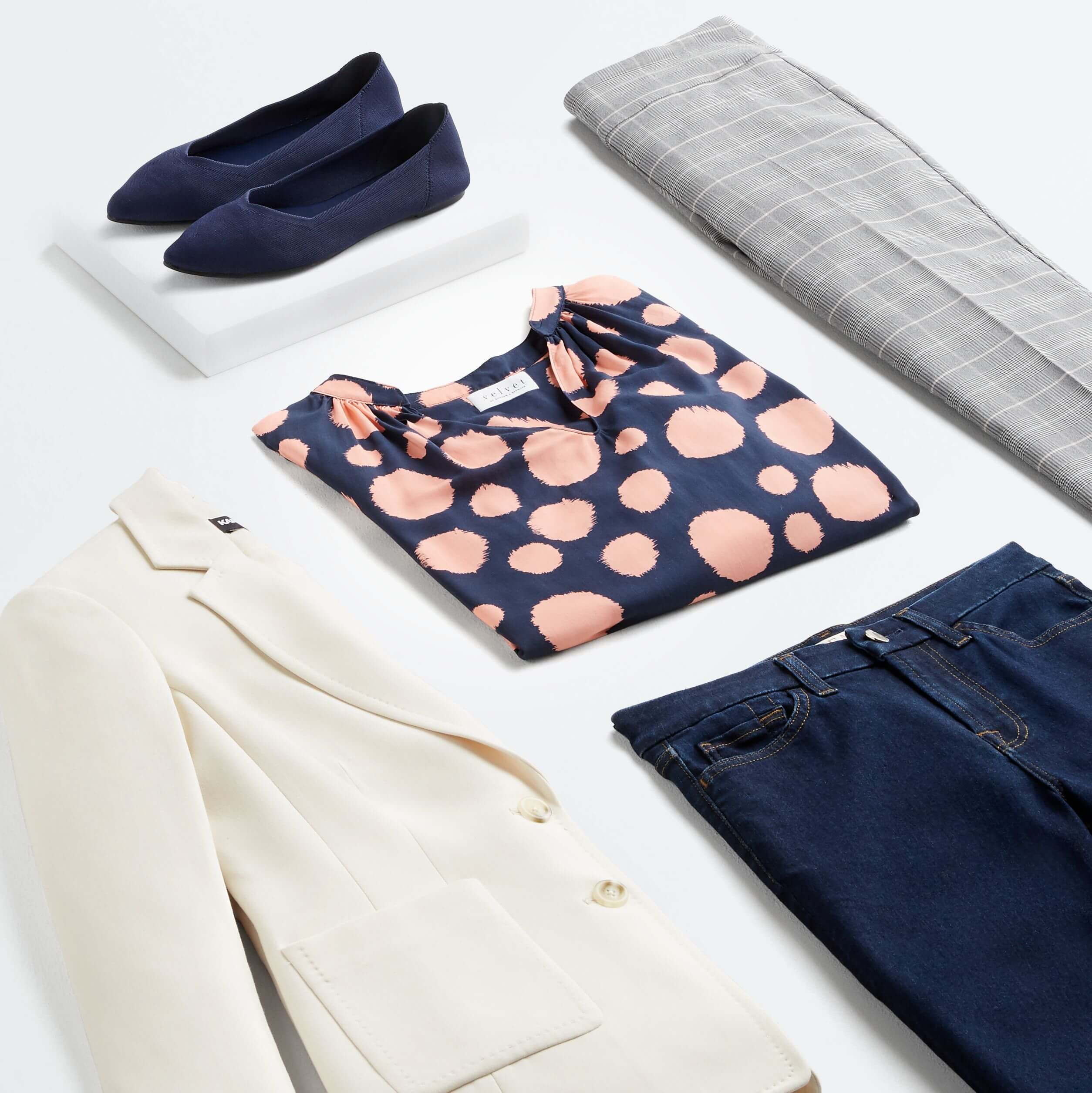 Stitch Fix women’s spring 2022 fashion with cream blazer, pink and blue patterned blouse, jeans, grey and white slacks and navy flats.