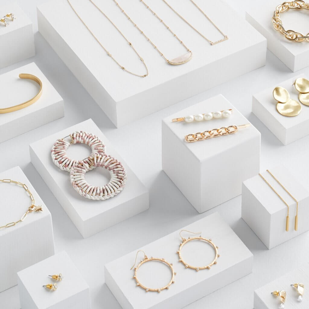 Stitch Fix women’s array of accessories to pair with a navy blue dress for a wedding with earrings, necklaces, hair clips.