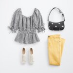 Stitch Fix women's Y2K fashion outfit with gingham short-sleeve smocked top, yellow jeans, floral bag and white sneakers.