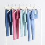 Stitch Fix women's collection yoga outfits hanging on rack featuring matching tops and leggings.