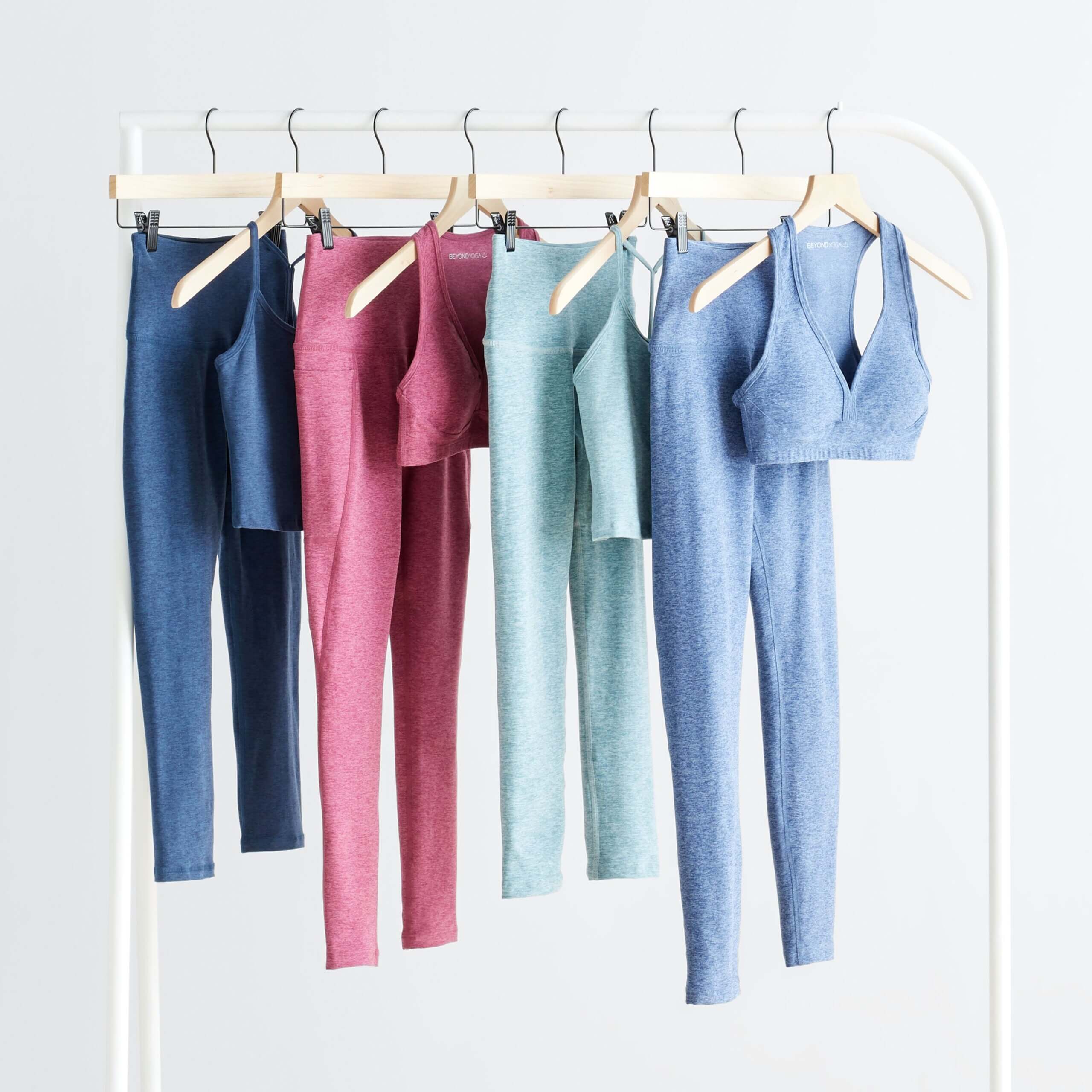 Stitch Fix women's collection yoga outfits hanging on rack featuring matching tops and leggings.