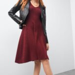 Stitch Fix women's Valentine's Day outfit on model wearing black moto jacket over burgundy dress and lug sole boots.