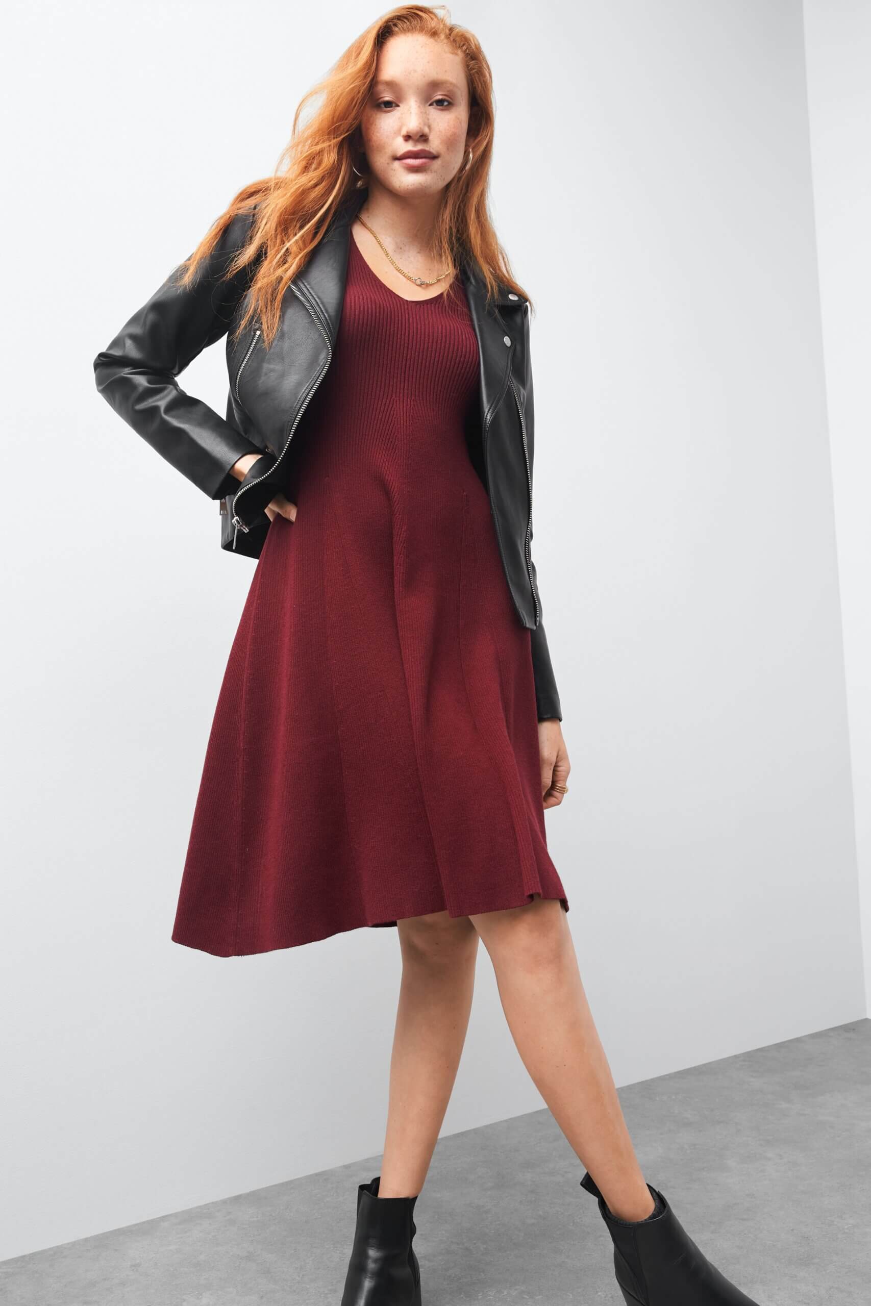 Stitch Fix women's Valentine's Day outfit on model wearing black moto jacket over burgundy dress and lug sole boots.