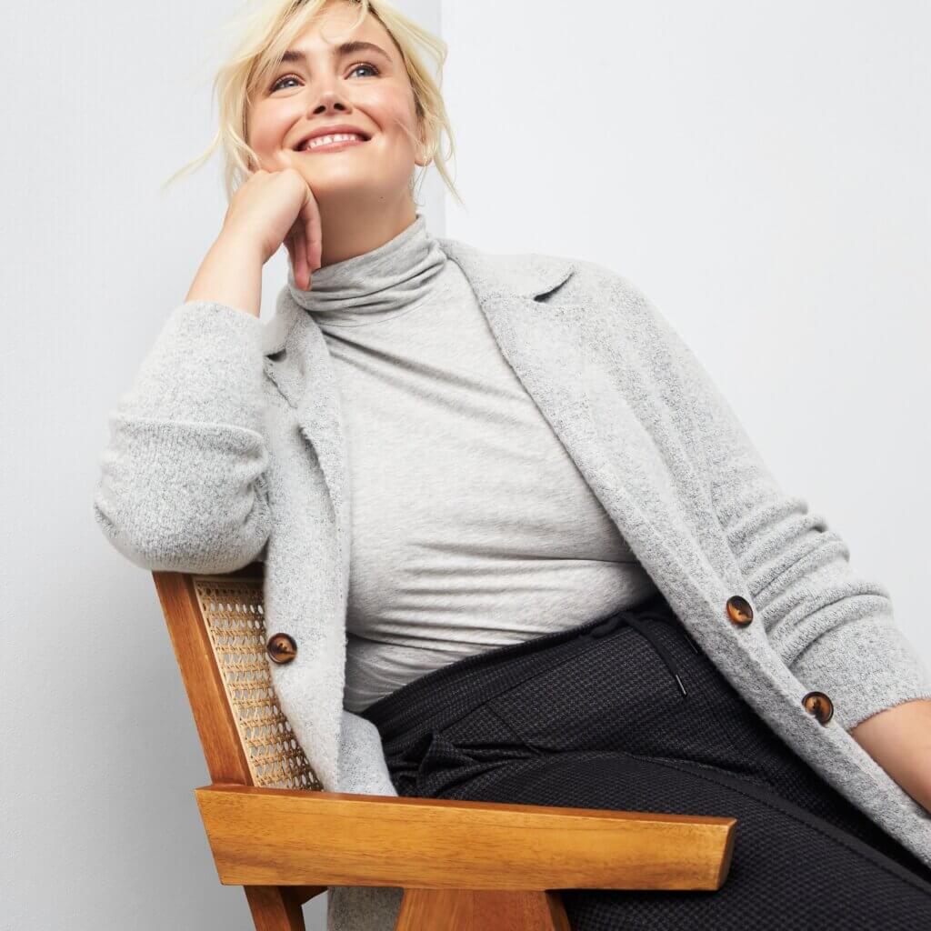 Stitch Fix model wearing women's business professional attire outfit featuring a turtleneck top, grey cardigan and black pants.