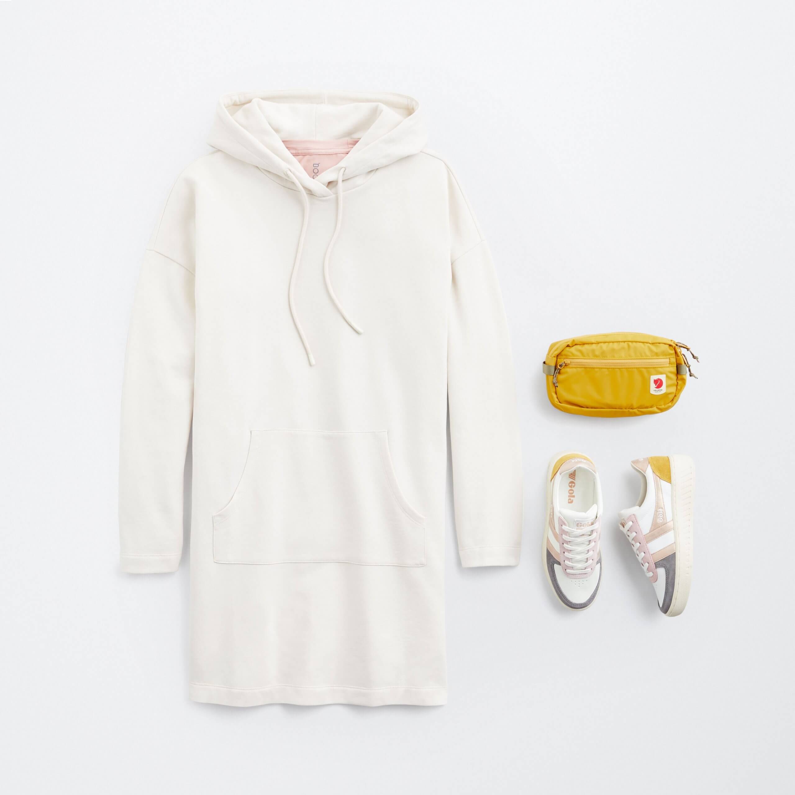 Stitch Fix women’s little white dress outfit with white long-sleeve athleisure dress, mustard hip pack and colorful sneakers.