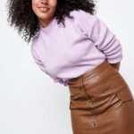 Stitch Fix model wearing brown faux leather button-up mini skirt outfit with a lavender sweater.