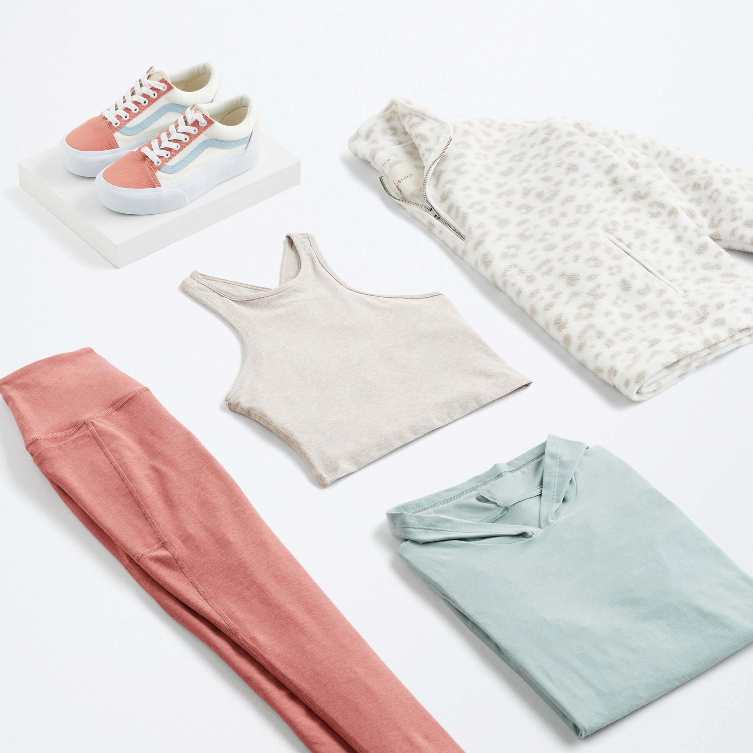 Stitch Fix women’s spring 2022 fashion with light grey crop top, pink leggings, light blue hoodie, quarter-zip and colorful sneakers.
