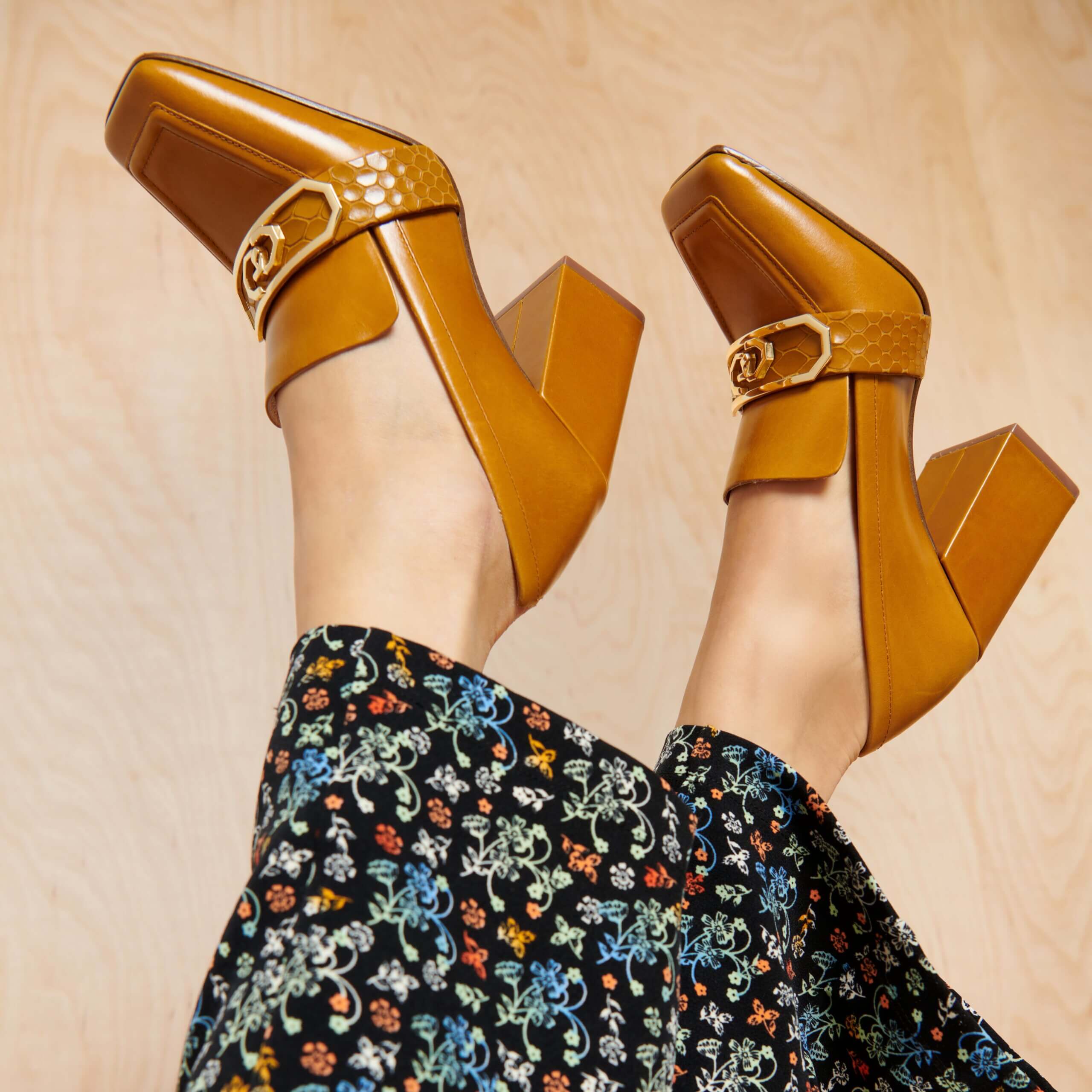 Stitch Fix Women’s model wearing pumpkin patch style multi-colored floral bottoms and brown loafer heels.