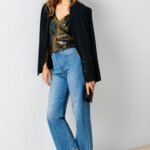 Stitch Fix women’s model wearing a black blazer, sequin blouse, wide-leg jeans and silver heels.