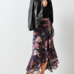 Stitch Fix model wearing women’s business formal outfit with navy floral midi skirt, black blouse and faux leather blazer.