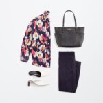 Stitch Fix women’s business formal outfit with navy and pink floral blouse, navy trousers, white heels and black tote bag.