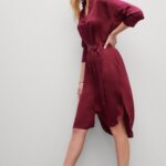 Stitch Fix women’s model wearing burgundy three-quarter sleeve shirt dress and light brown heeled booties.