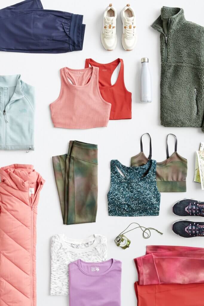Stitch Fix women’s hiking attire in various colors and prints including sports bras, quarter zips, leggings, joggers, T-shirts and sneakers.